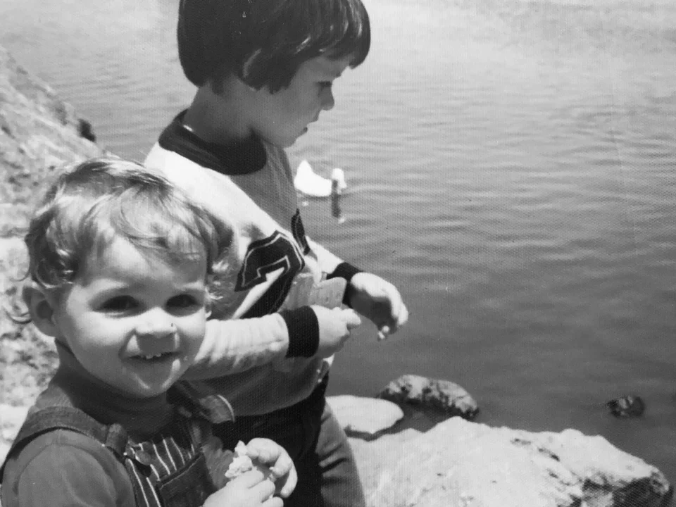 Chad and his brother Scott beside a duck pond as children.