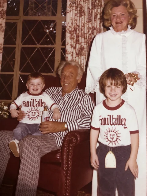 Chad on his grandfather’s lap in the den, with Nana and his brother Scott.