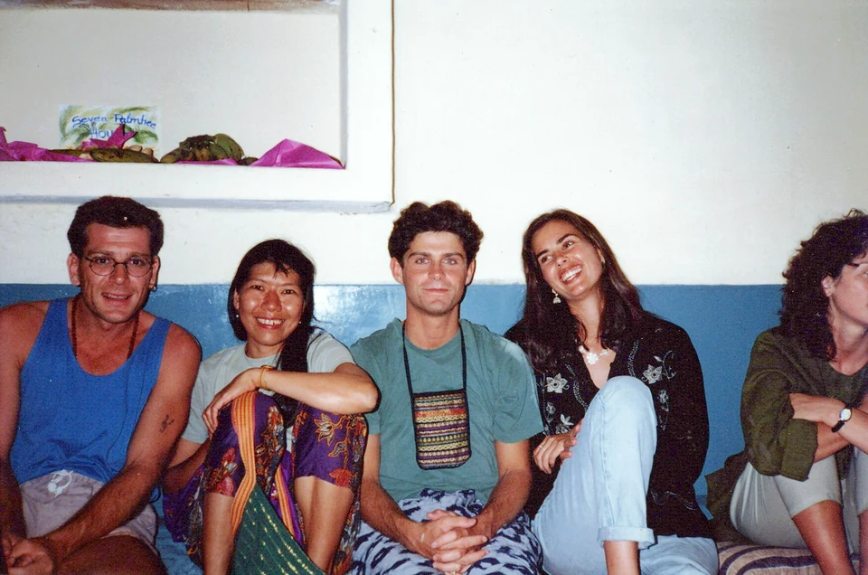 Chad seated on the floor with friends at a party in Mysore.